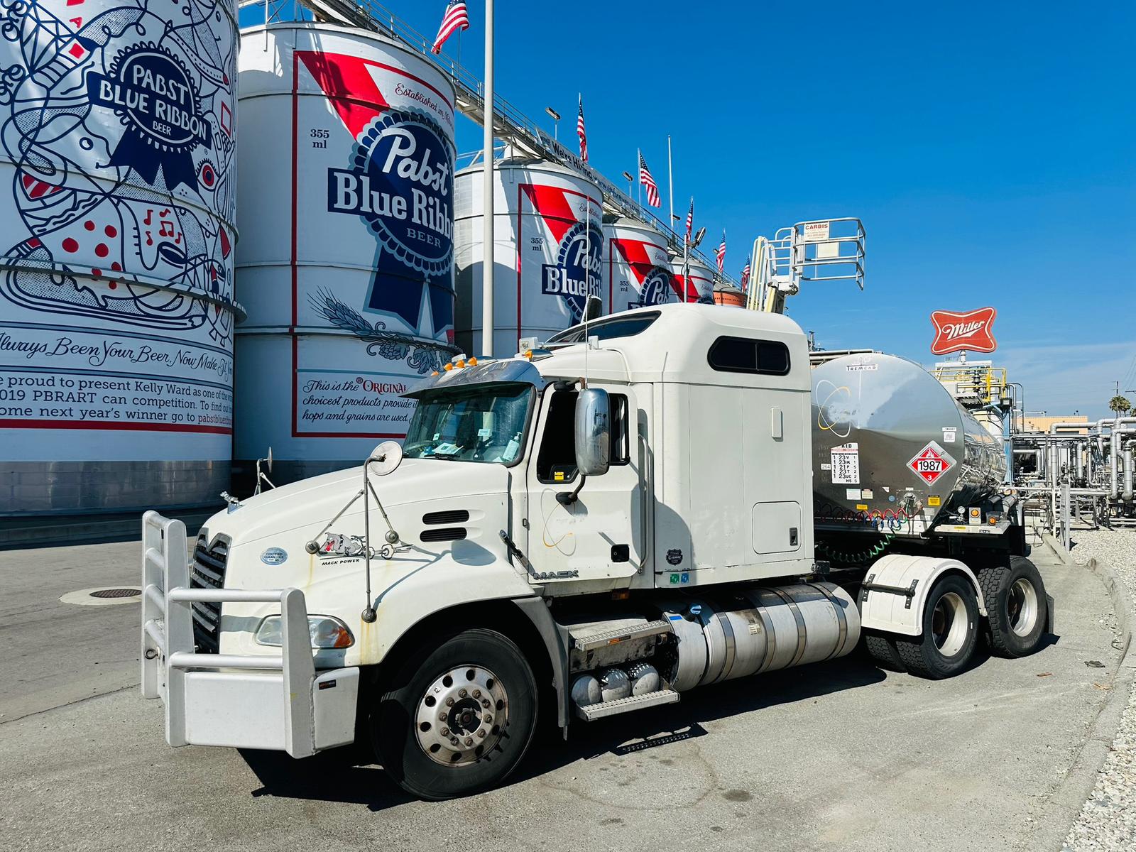 Amar’s white Mack tanker truck at a loading facility